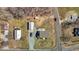 Aerial view of home with white detached garage, gravel driveway, road, and surrounding lawn at 3307 Altamahaw Church St, Elon, NC 27244