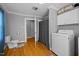 Functional bathroom includes a toilet, shower, washing machine, and convenient storage cabinets at 3307 Altamahaw Church St, Elon, NC 27244
