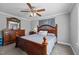 Comfortable bedroom featuring a wooden bed frame, dresser, and a bright window at 3307 Altamahaw Church St, Elon, NC 27244