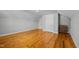 This bedroom features hardwood floors, large windows, and a neutral color scheme at 3307 Altamahaw Church St, Elon, NC 27244