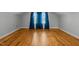 This room features wood floors, large windows with curtains, and a neutral color scheme at 3307 Altamahaw Church St, Elon, NC 27244