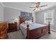 Cozy bedroom with a ceiling fan, soft gray walls, carpet floors and a large window at 3307 Altamahaw Church St, Elon, NC 27244