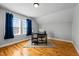 Bright bedroom with hardwood floors, featuring a desk, chair, and two large windows with natural light at 3307 Altamahaw Church St, Elon, NC 27244