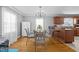 Dining room with decorative metal chairs, chandelier, and view of kitchen bar at 3307 Altamahaw Church St, Elon, NC 27244