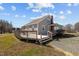 Rear exterior view of the home with a wooden deck, perfect for outdoor entertainment at 3307 Altamahaw Church St, Elon, NC 27244