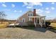 Rear exterior view of home showing wooden deck and gravel driveway at 3307 Altamahaw Church St, Elon, NC 27244