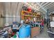 Spacious garage featuring work bench, tool storage, and corrugated metal walls and ceiling at 3307 Altamahaw Church St, Elon, NC 27244