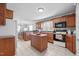 Spacious kitchen featuring wood cabinets, white appliances, and an island at 3307 Altamahaw Church St, Elon, NC 27244