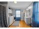 Bright laundry room with washer, dryer, wooden floors and natural light from window at 3307 Altamahaw Church St, Elon, NC 27244