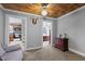 Neutral living room featuring wood ceiling, plush carpeting and furniture pieces with a peek into other rooms at 3307 Altamahaw Church St, Elon, NC 27244