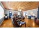 Cozy living room with wood-paneled ceiling, fireplace, and hardwood floors at 3307 Altamahaw Church St, Elon, NC 27244