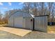 Exterior of metal outbuilding with sliding door, service door, and concrete pad at 3307 Altamahaw Church St, Elon, NC 27244