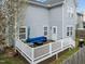 View of the back exterior showing the deck, siding, yard, and windows of this two-story home at 3809 Mardela Spring Dr, Raleigh, NC 27616