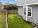 This is a green backyard with a privacy fence and view to the house at 3809 Mardela Spring Dr, Raleigh, NC 27616