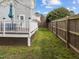 Side yard and deck offer a relaxing outdoor space next to a privacy fence, perfect for entertaining at 3809 Mardela Spring Dr, Raleigh, NC 27616