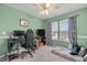 This is a green bedroom with a ceiling fan, neutral carpet and large windows at 3809 Mardela Spring Dr, Raleigh, NC 27616