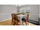 Dining area enhanced by hardwood flooring, neutral wall paint and plenty of natural light at 3809 Mardela Spring Dr, Raleigh, NC 27616