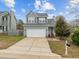 Two-story home with an attached garage, a neatly kept lawn, and a welcoming front entrance at 3809 Mardela Spring Dr, Raleigh, NC 27616