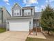 Charming two-story home with a well-maintained lawn, attached garage, and a welcoming entrance at 3809 Mardela Spring Dr, Raleigh, NC 27616