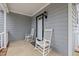 This porch has two white rocking chairs and a secured door at 3809 Mardela Spring Dr, Raleigh, NC 27616
