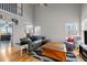 Spacious living room featuring hardwood floors, a high ceiling, and plenty of natural light from multiple windows at 3809 Mardela Spring Dr, Raleigh, NC 27616