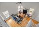 Open-concept living room with hardwood floors, neutral paint, and large windows for natural light at 3809 Mardela Spring Dr, Raleigh, NC 27616