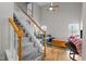 Bright living room featuring hardwood floors, a high ceiling, a staircase, and ample natural light at 3809 Mardela Spring Dr, Raleigh, NC 27616
