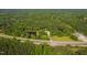 Aerial view featuring the house, lush surrounding forest, two ponds, and proximity to the road at 4200 Us 1 Highway South, Kittrell, NC 27544