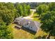 Aerial view of a home with a deck and mature trees, showcasing the roof and backyard at 4200 Us 1 Highway South, Kittrell, NC 27544