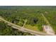 Aerial view featuring the house, lush surrounding forest, two ponds, and proximity to the road at 4200 Us 1 Highway South, Kittrell, NC 27544