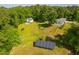 Aerial view of home and yard with solar panels in the distance at 4200 Us 1 Highway South, Kittrell, NC 27544