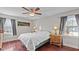 Bright bedroom with two windows, wood floors, ceiling fan, and bedside lamps at 4200 Us 1 Highway South, Kittrell, NC 27544