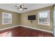 Bedroom featuring two bright windows and dark wood flooring with a ceiling fan at 4200 Us 1 Highway South, Kittrell, NC 27544