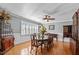 Elegant dining room featuring hardwood floors, plantation shutters, and a classic chandelier at 4200 Us 1 Highway South, Kittrell, NC 27544