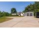 Charming ranch home with a red door, attached garage, and a well-manicured lawn and concrete driveway at 4200 Us 1 Highway South, Kittrell, NC 27544