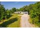 White home featuring an attached garage, situated on a well-maintained lawn with a lengthy driveway at 4200 Us 1 Highway South, Kittrell, NC 27544