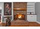 Close up of brick fireplace with rustic wood mantle and built-in white shelves and cabinets at 4200 Us 1 Highway South, Kittrell, NC 27544