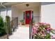 Inviting front entrance with a red door, complemented by blooming flowers and well-maintained landscaping at 4200 Us 1 Highway South, Kittrell, NC 27544