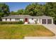 Charming, white-brick home with a well-manicured lawn and eye-catching red front door at 4200 Us 1 Highway South, Kittrell, NC 27544