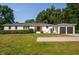 Inviting single-story home with a bright red door, beautiful landscaping, and a two-car attached garage at 4200 Us 1 Highway South, Kittrell, NC 27544