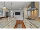 Open kitchen with granite countertops, stainless steel appliances, and access to the living area at 4200 Us 1 Highway South, Kittrell, NC 27544