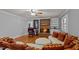 Cozy living room features brick fireplace, hardwood floors, and a stylish sectional sofa at 4200 Us 1 Highway South, Kittrell, NC 27544