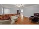 Spacious living room with hardwood floors and modern, neutral-toned furniture and open doorway at 4200 Us 1 Highway South, Kittrell, NC 27544