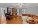 Cozy living room with a brick fireplace, hardwood floors, and comfortable seating at 4200 Us 1 Highway South, Kittrell, NC 27544