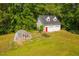 Outbuilding with two garage doors, a red door, and greenhouse at 4200 Us 1 Highway South, Kittrell, NC 27544