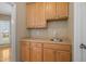 A mudroom features natural wood cabinets, a sink and faucet, as well as electrical outlets above the sink at 4904 Goosedown Ct, Raleigh, NC 27604