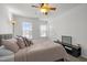 Cozy bedroom featuring neutral walls, plush carpet, large windows for natural light, and modern bedside decor at 5332 Seaspray Ln, Raleigh, NC 27610