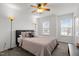 Comfortable bedroom featuring neutral walls, plush carpet, large windows for natural light, and modern lamps at 5332 Seaspray Ln, Raleigh, NC 27610