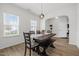 Inviting dining room with large windows and modern pendant lighting over the dark wood table at 5332 Seaspray Ln, Raleigh, NC 27610