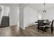 Open dining area with wood-look floors, with views to the stairs and the home's entrance at 5332 Seaspray Ln, Raleigh, NC 27610
